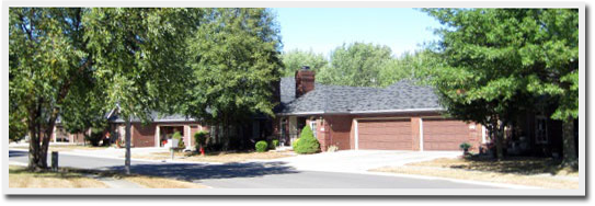 A picture of a house with trees in front of it