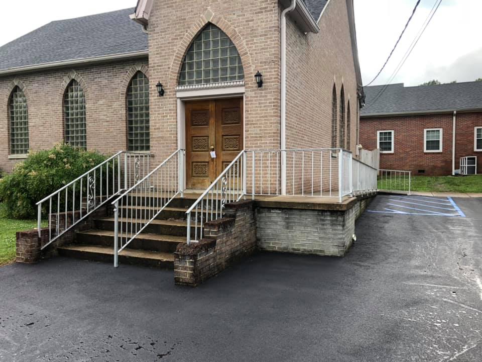 A church with stairs leading up to the front door
