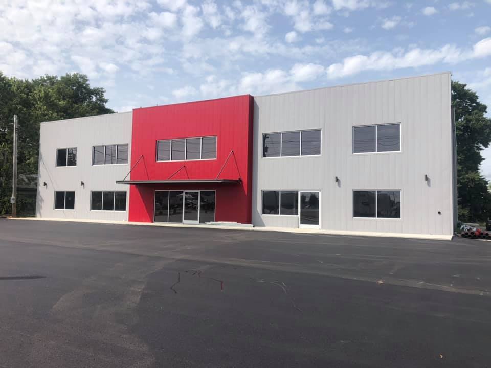 A large white and red building with a lot of windows.