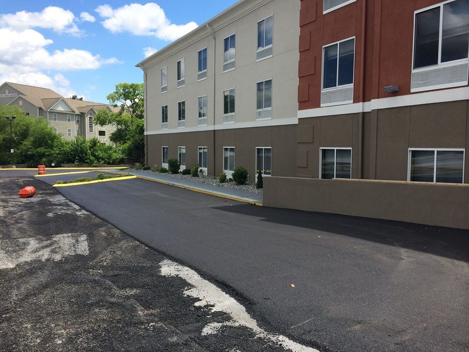 A large building with a parking lot in front of it