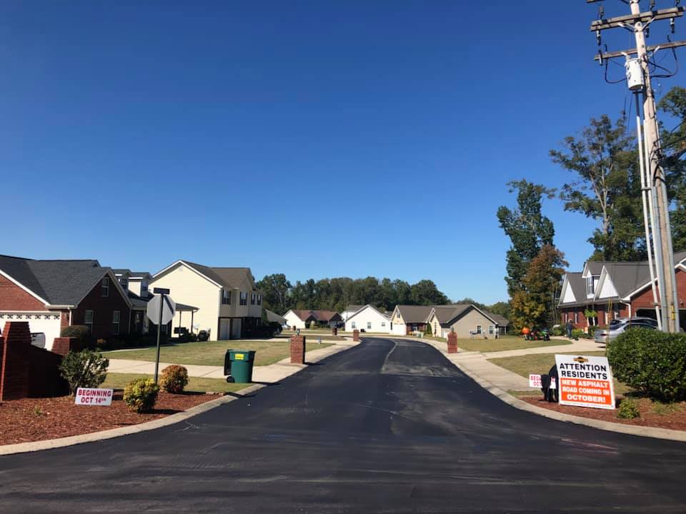 A residential street with a sign that says service on opportunity