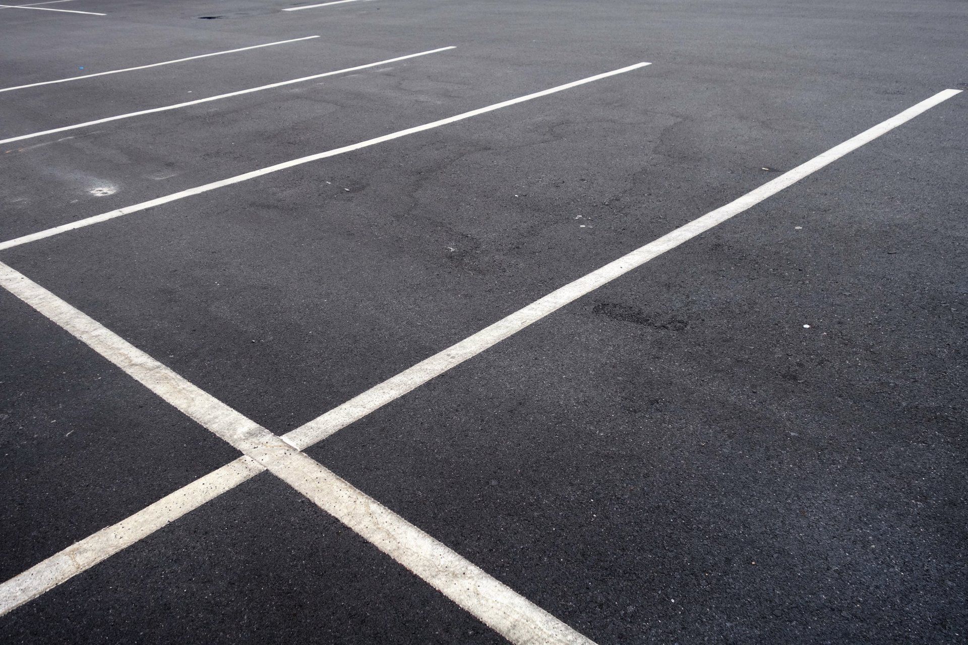 An empty parking lot with white lines on it