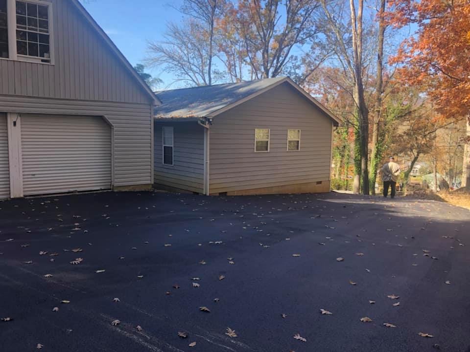 A house with a garage and a driveway in front of it.