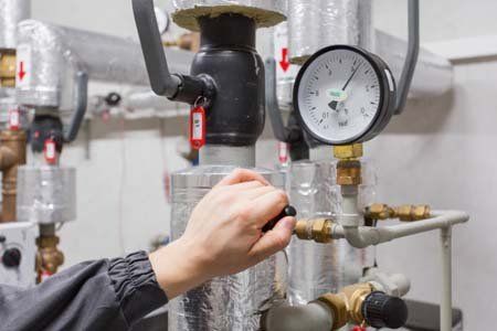 Technician checking pressure Technician checking pressure