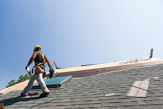 Roofer installing flashing on skylight - residential roofing in Clay Center, KS Roofer installing flashing on skylight - residential roofing in Clay Center, KS