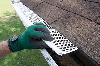 Contractor Adjusting Plastic Gutter Guards - composition roofing in Clay Center, KS Contractor Adjusting Plastic Gutter Guards - composition roofing in Clay Center, KS