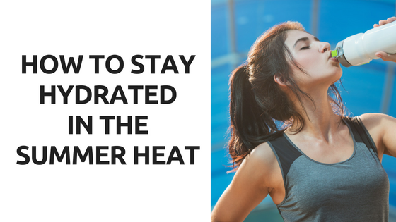 A woman is drinking water from a bottle in the summer heat.