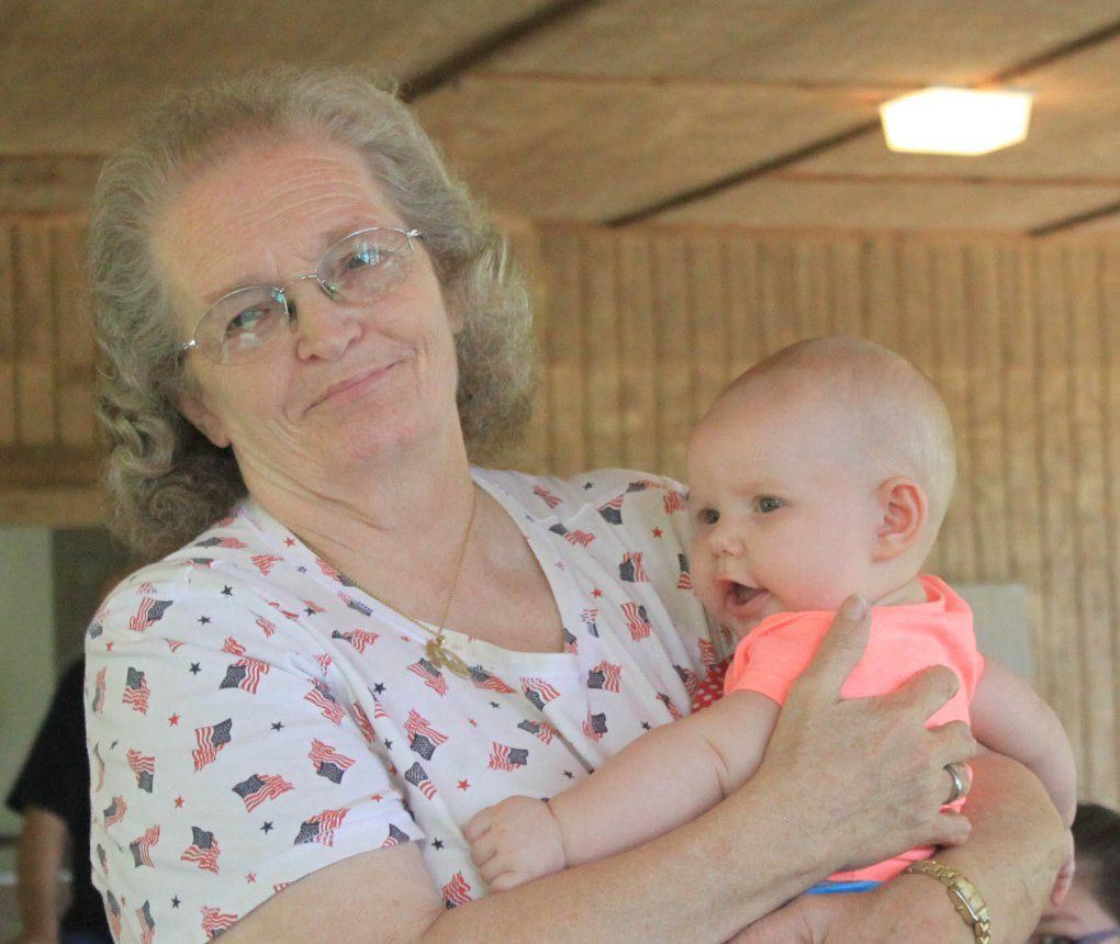 Member holding a baby.