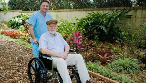 Male nurse helping an old man