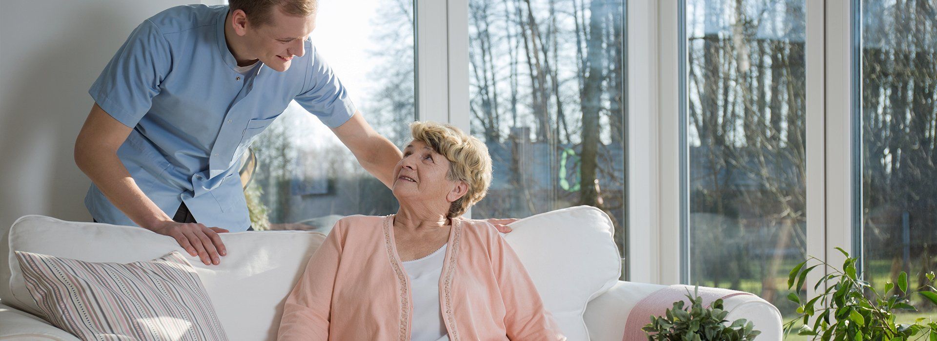 An old lady talking to a nurse