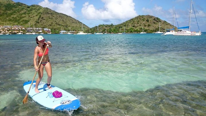 Woman strongly paddle boarding