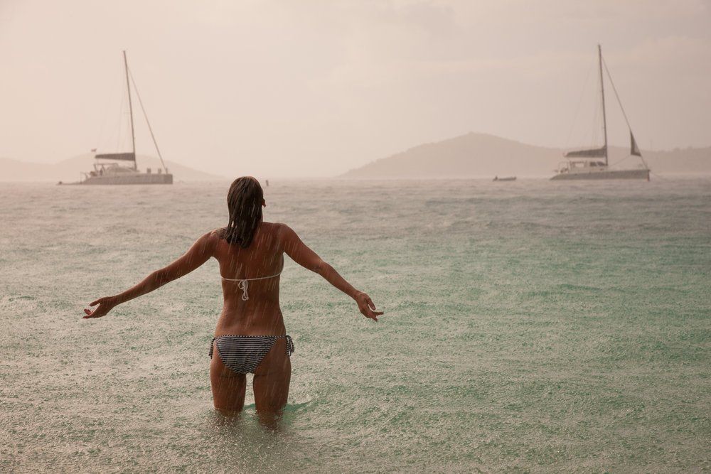 Woman in bikini starring at the rain