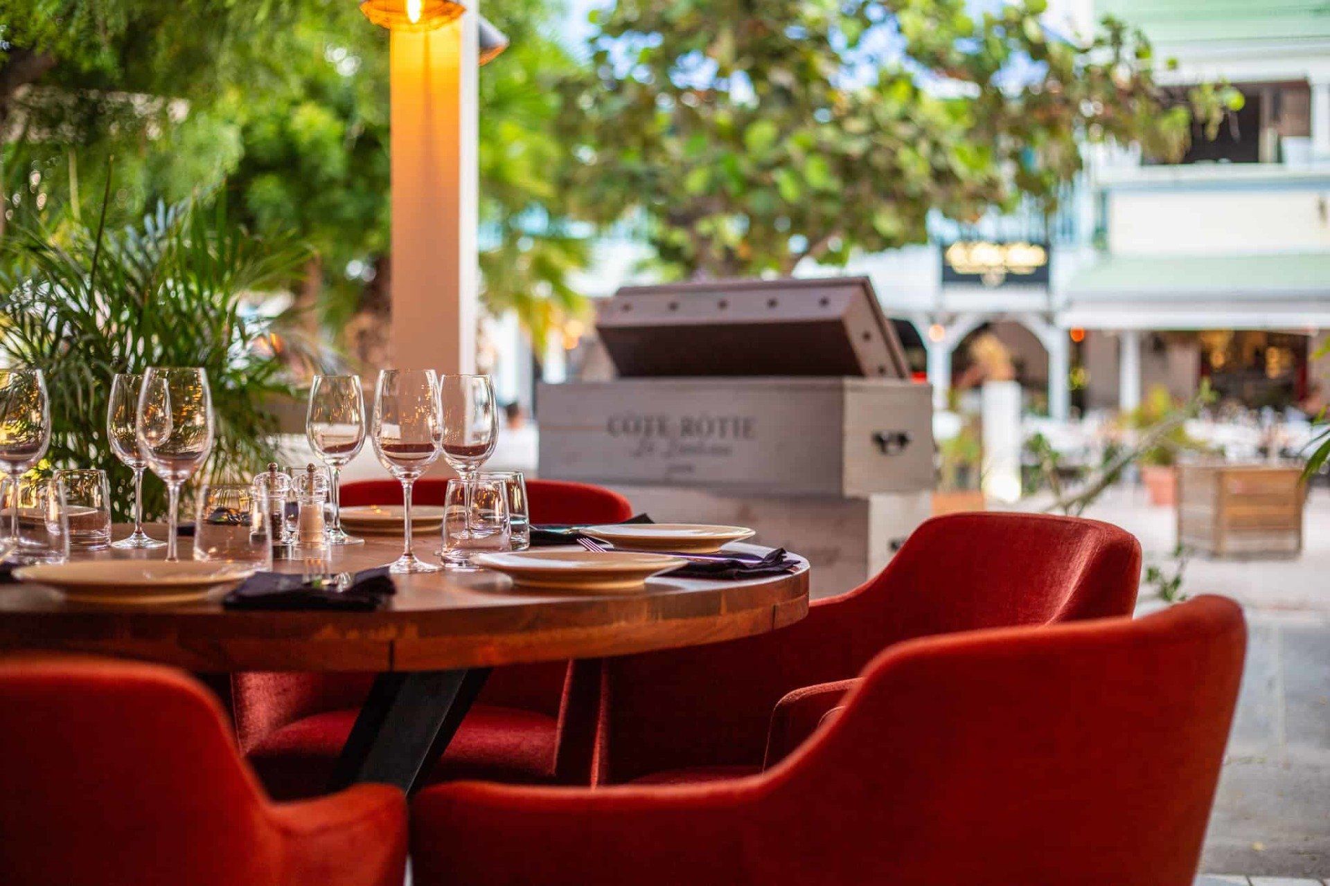 A restaurant with a table and chairs set up for a meal.