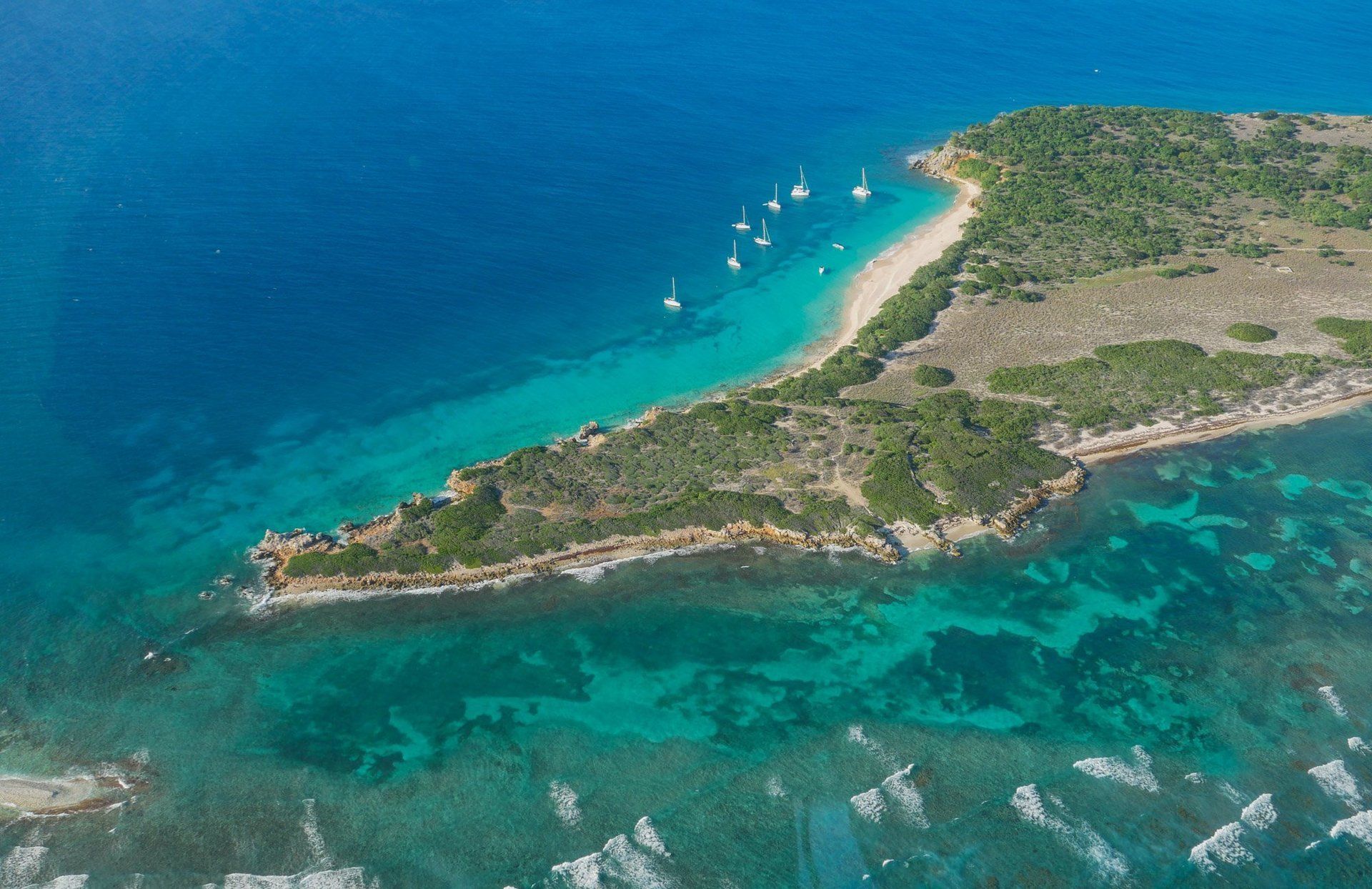 An aerial view of a small island in the middle of the ocean.