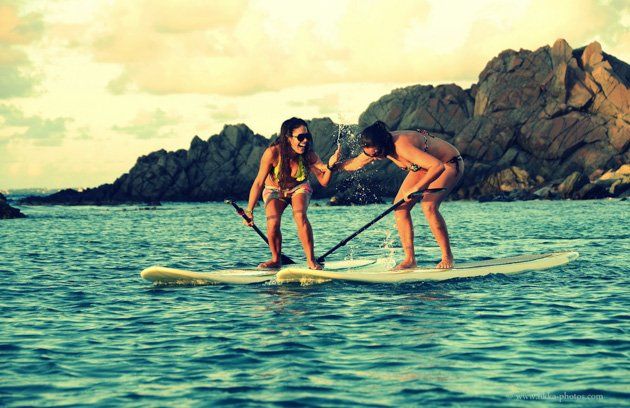 2 girls on a paddle board at Creole Rock
