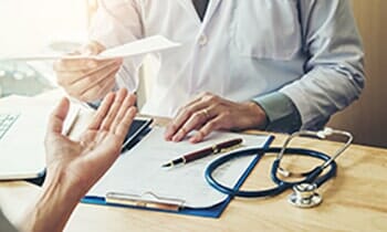 Doctor or physician writing diagnosis — one-stop surgical and non-surgical facility in Orland Park, IL Doctor or physician writing diagnosis — one-stop surgical and non-surgical facility in Orland Park, IL