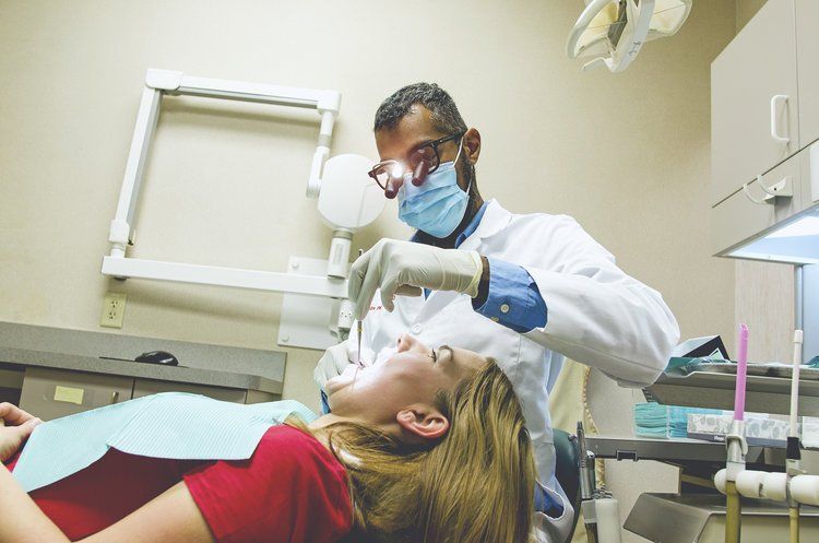 Dentist working on dental implants, snap on dentures, and bridges | Monroe Township NJ