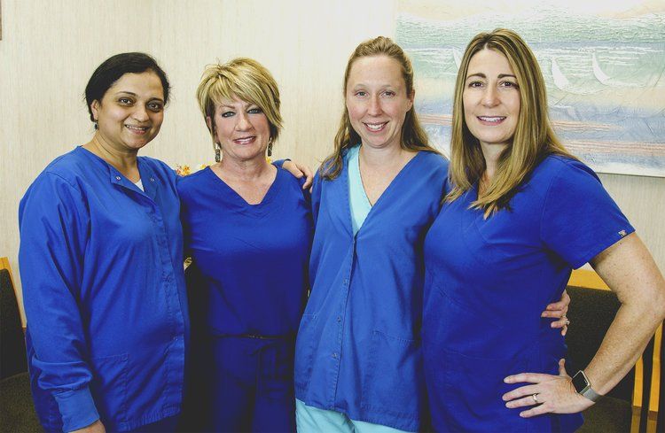 Friendly dental staff smiling for photo | Dental Bridges, Snap on Dentures, Dental Implants | Monroe Township NJ