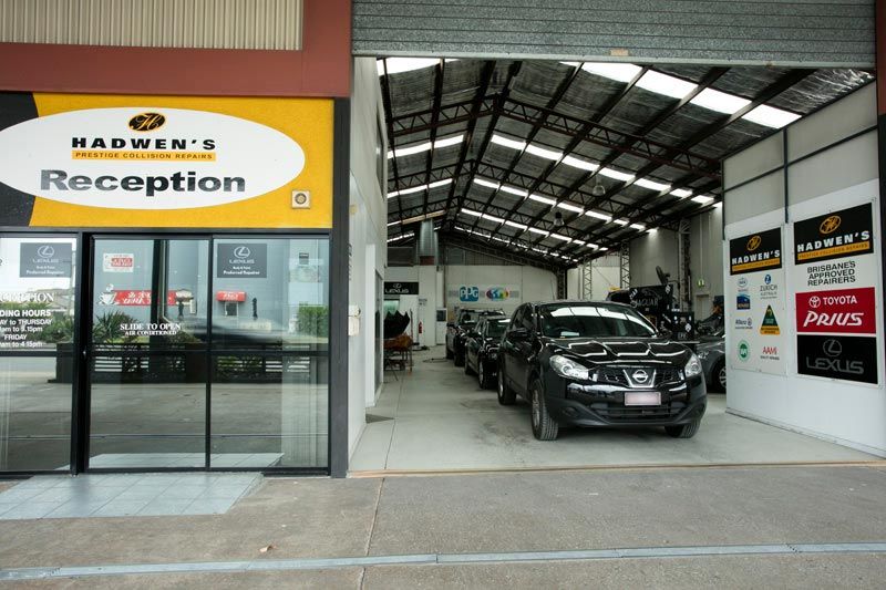 cars in shop next to reception desk