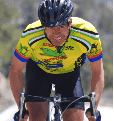 A man wearing a helmet is riding a bike