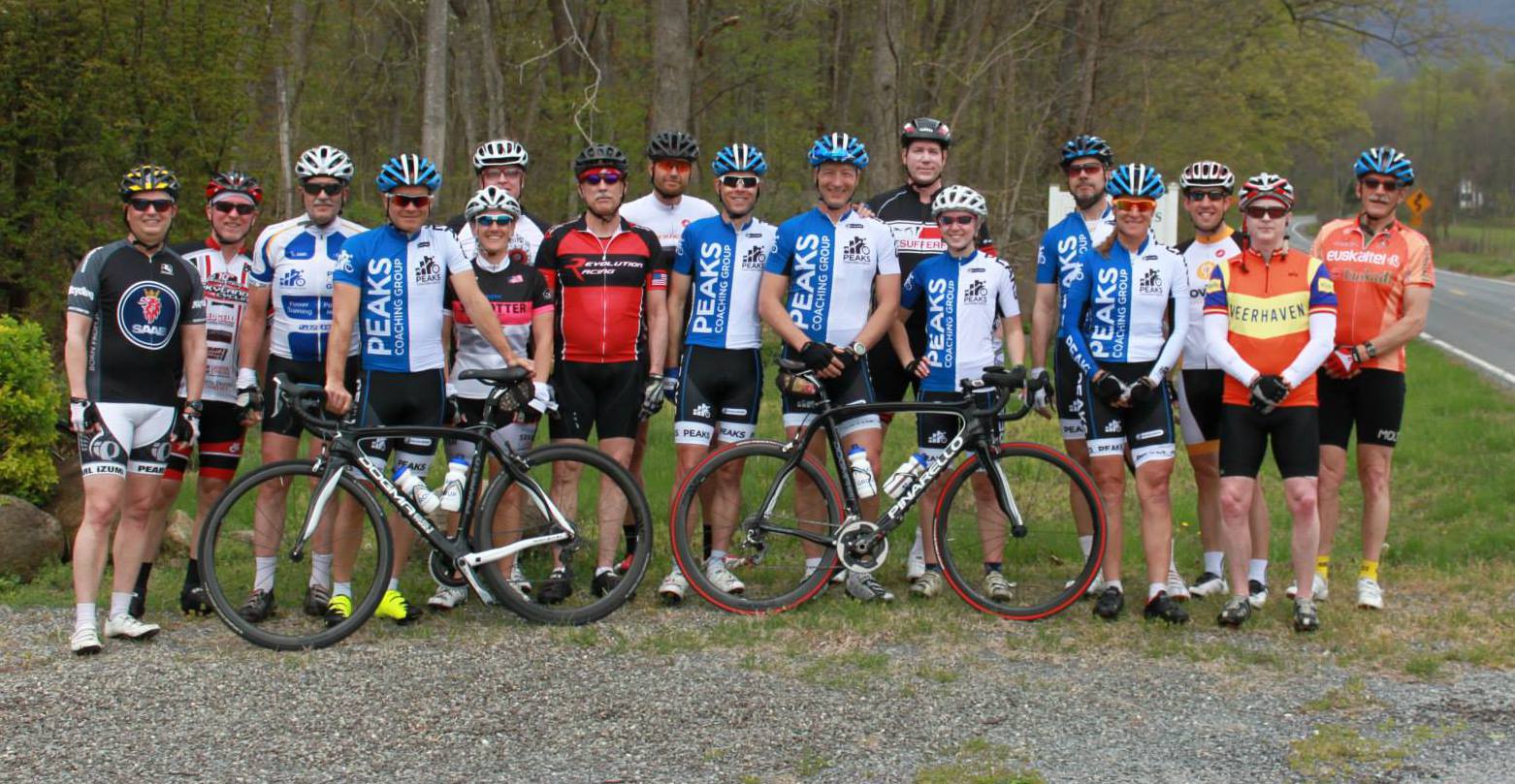 A group of cyclists are posing for a picture with their bikes.