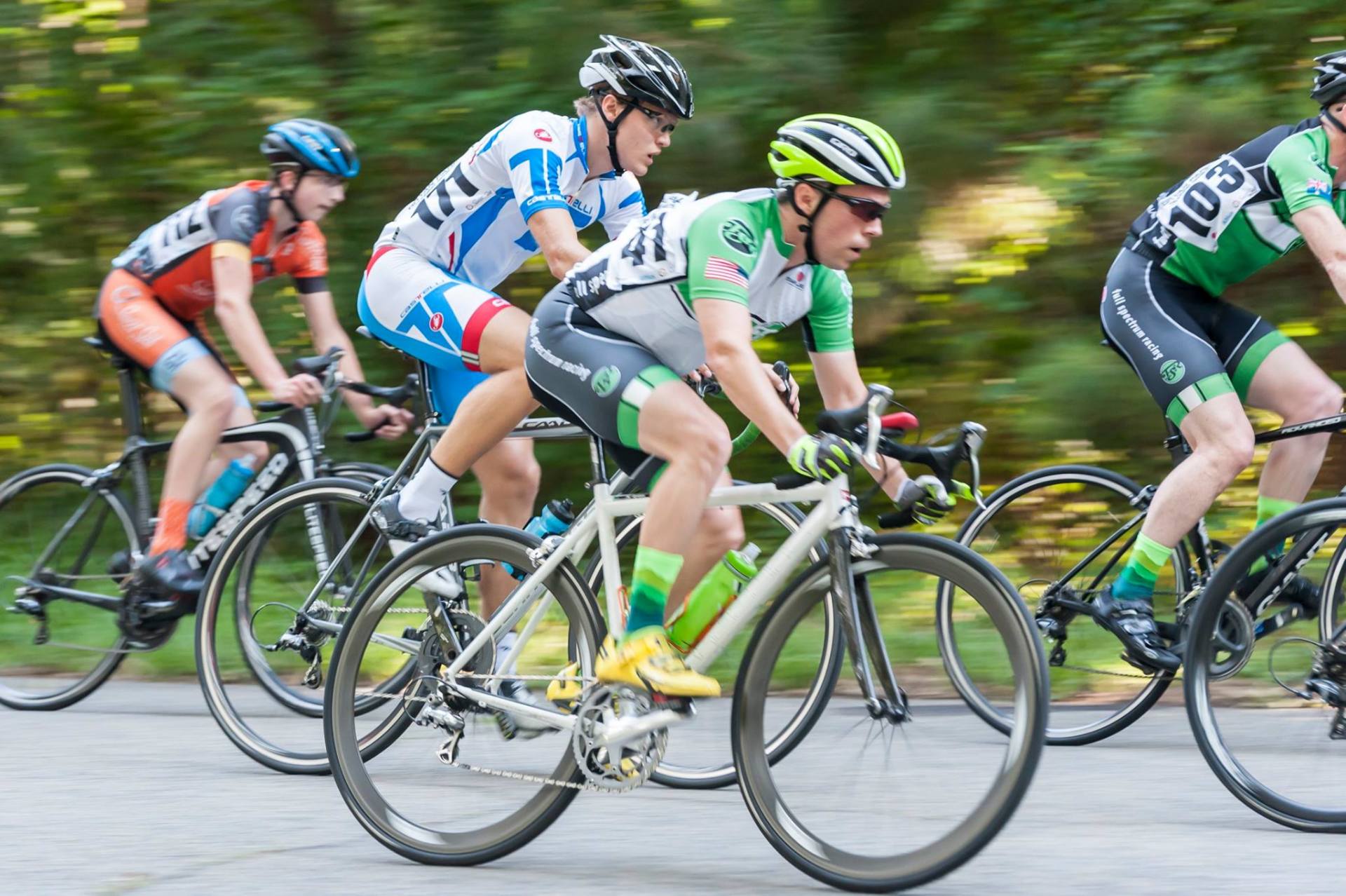 A group of people are riding bicycles down a road.