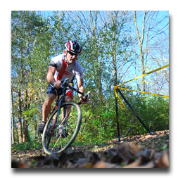 A man wearing a helmet is riding a bike on a trail