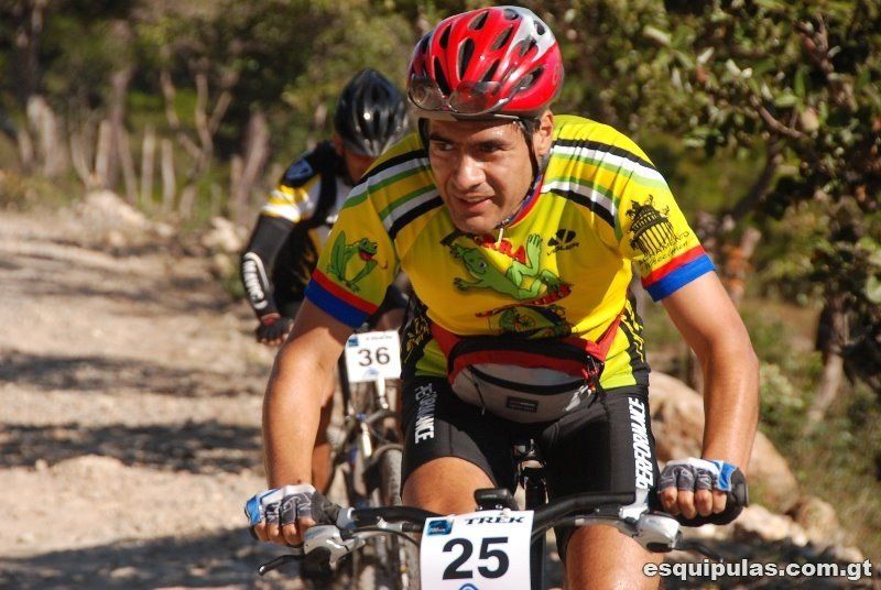 A man riding a bike with the number 25 on the handlebars