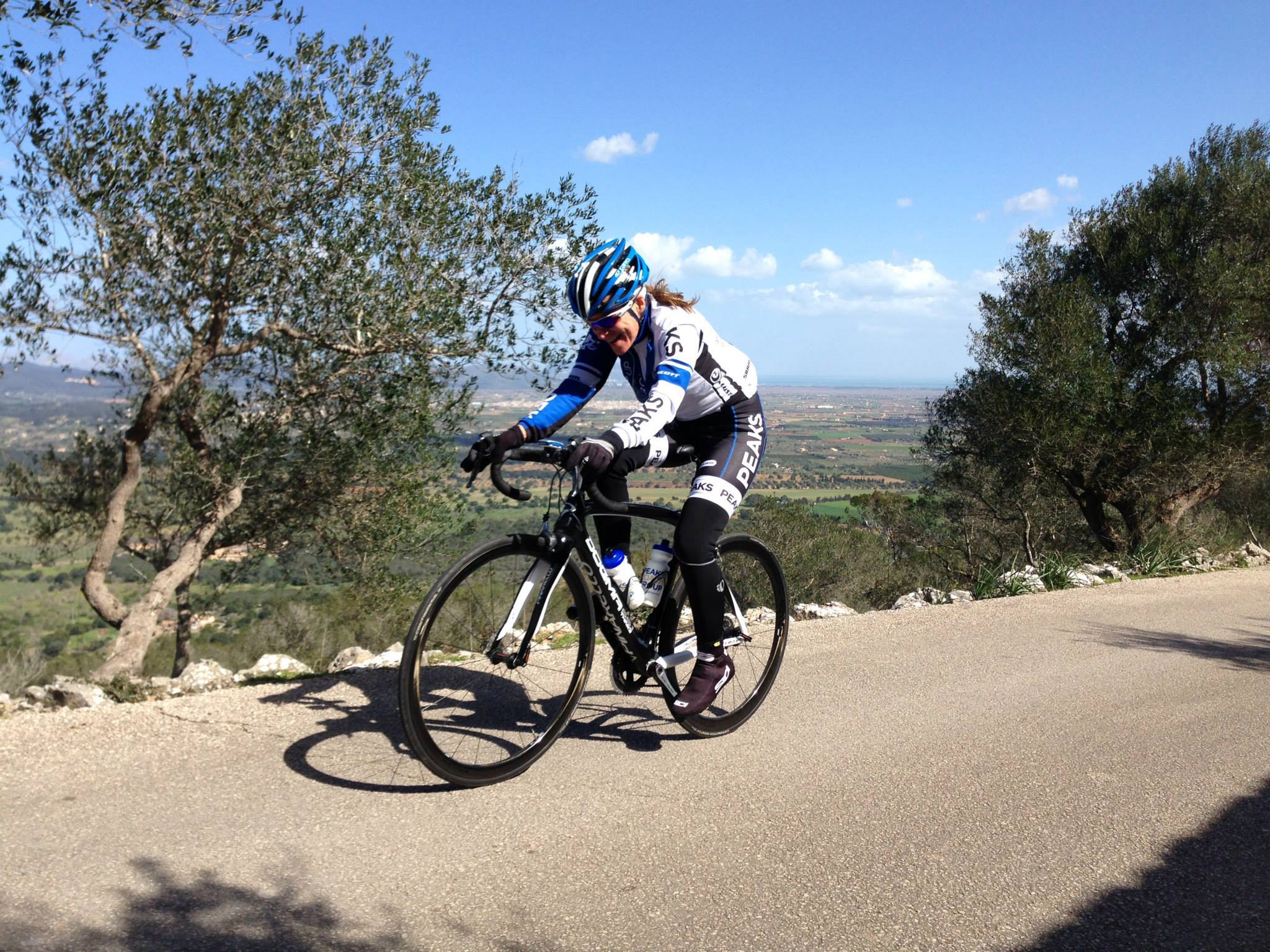 A person is riding a bike down a hill on a road.