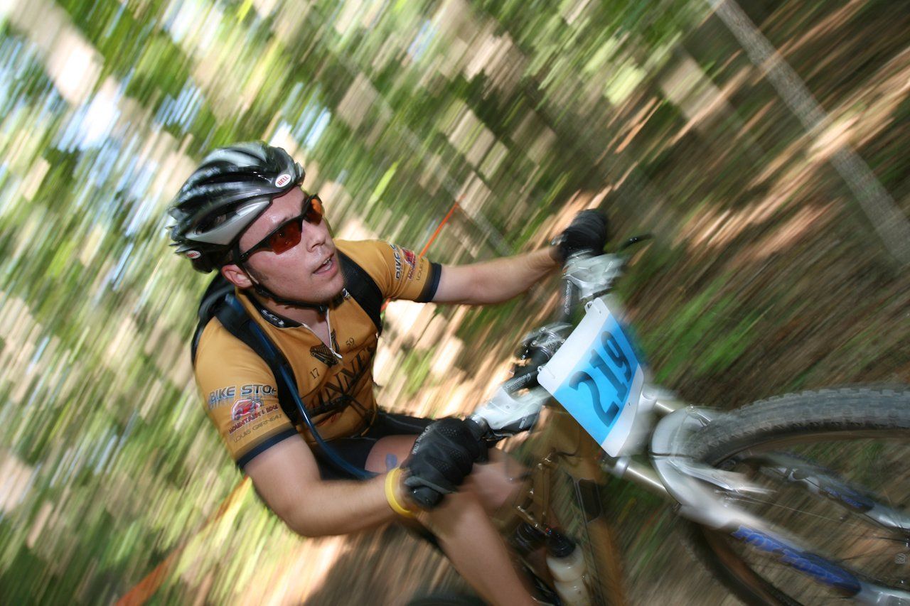 A man riding a bike with the number 219 on the handlebars
