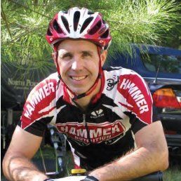A man wearing a helmet and a hammer nutrition jersey