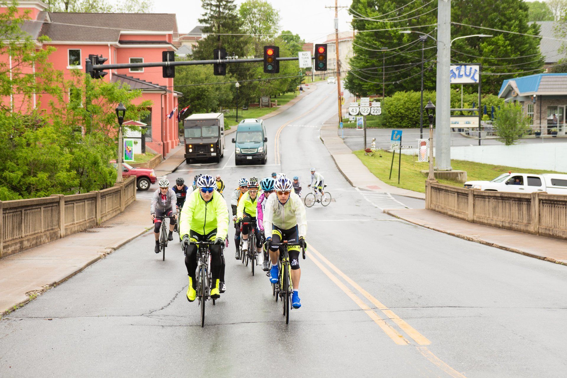 A group of people are riding bicycles down a street.