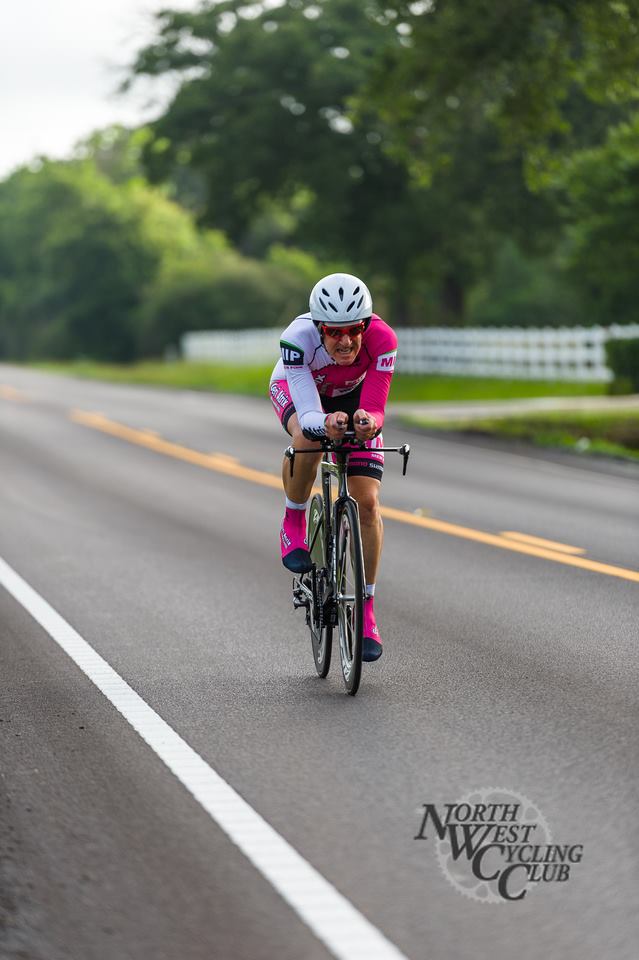 A person is riding a bike down a road.