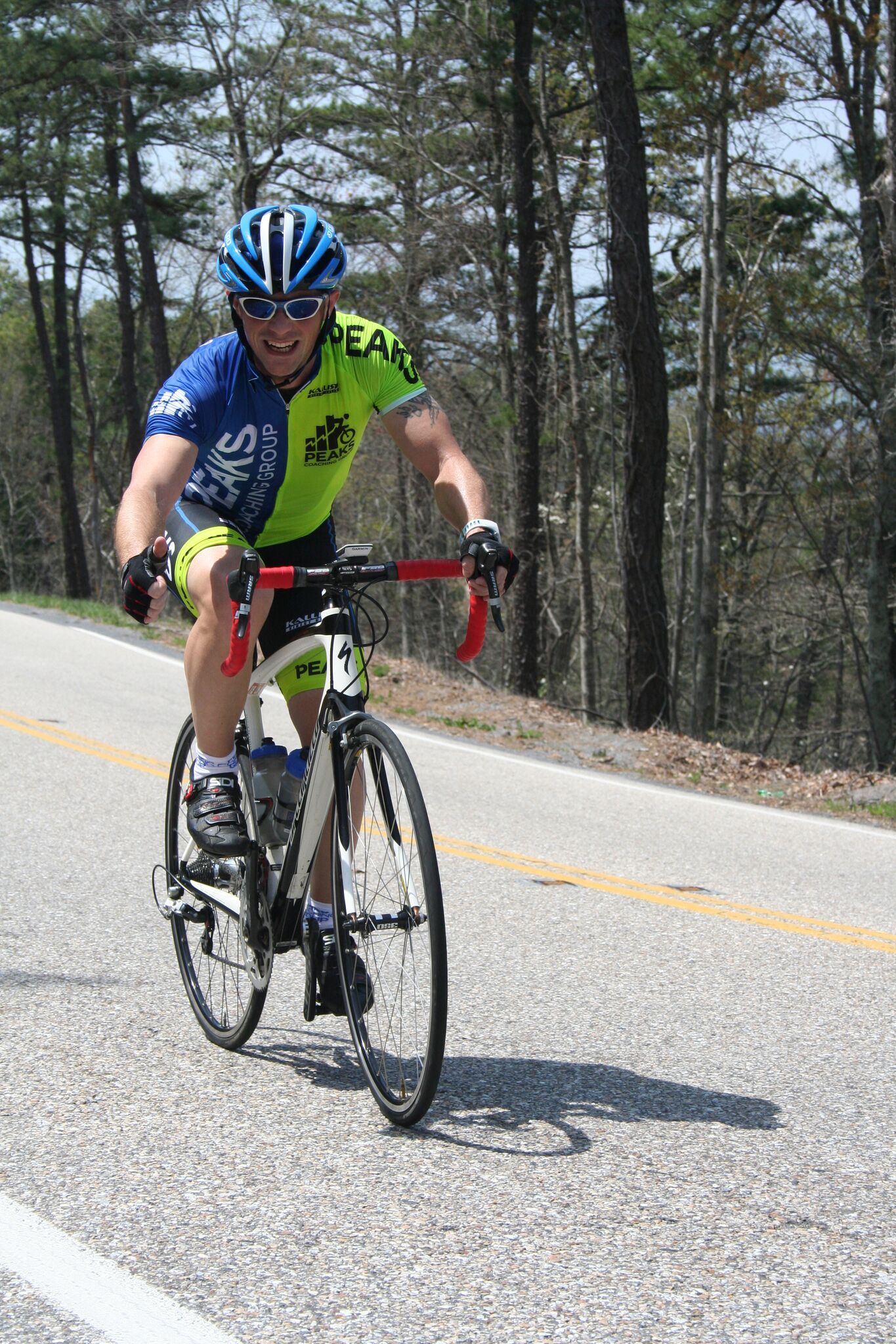 A man is riding a bike down a road.