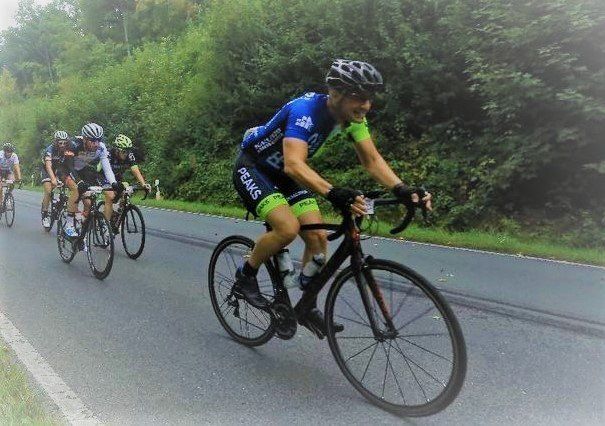 A group of people are riding bicycles down a road.