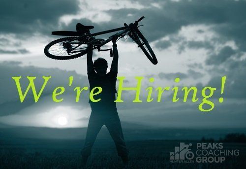 A silhouette of a person holding a bicycle with the words we 're hiring behind them
