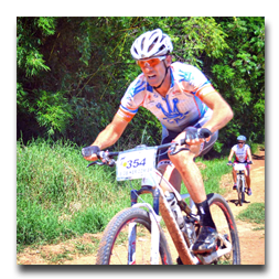 A man riding a bike with the number 354 on the front