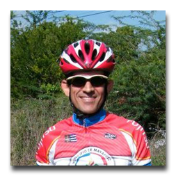 A man wearing a red helmet and sunglasses is smiling