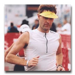 A man wearing a yellow visor is running