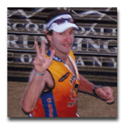 A man giving a peace sign in front of a sign that says running company