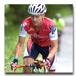 A man wearing a helmet is riding a bike