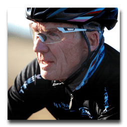 A man wearing a trek shirt and a helmet