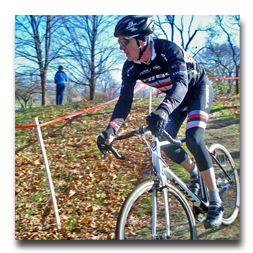A man wearing a trek jersey is riding a bike