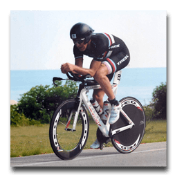 A man is riding a trek bike on a road