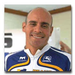 A man wearing a blue and white jersey with the letter m on it