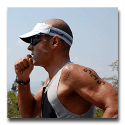 A man wearing a visor and sunglasses has a tattoo on his arm
