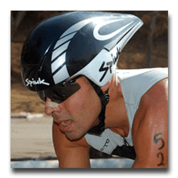 A man wearing a spink helmet and sunglasses