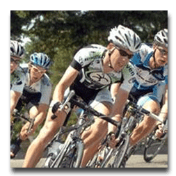 A group of people are riding bicycles down a road.