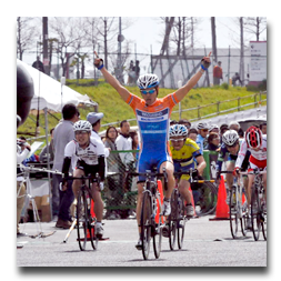A man riding a bike with his arms in the air
