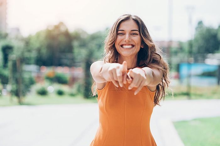 woman pointing and smiling